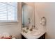Charming powder room with white marbled vanity, large mirror, and bright natural light at 39167 Braxton Ln, Elizabeth, CO 80107