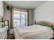 Cozy bedroom with a large window, neutral-toned walls, and a comfortable bed with knit blanket at 39167 Braxton Ln, Elizabeth, CO 80107
