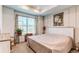 Bright bedroom with a large window, tray ceiling, and decorative floral wall art at 39167 Braxton Ln, Elizabeth, CO 80107