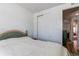 Bedroom with bed and a sliding door closet leading to open doorway and hardwood floor at 39167 Braxton Ln, Elizabeth, CO 80107