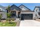 Charming single-Gathering home with a well-manicured lawn and inviting gray two-car garage at 39167 Braxton Ln, Elizabeth, CO 80107