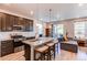 Open kitchen layout with island seating, stainless steel appliances, and patio access at 39167 Braxton Ln, Elizabeth, CO 80107