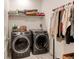 Well-organized laundry room featuring modern washer/dryer and ample shelving at 39167 Braxton Ln, Elizabeth, CO 80107