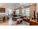 Open-concept living room showcases stylish furnishings, wood floors and a view to the deck at 39167 Braxton Ln, Elizabeth, CO 80107
