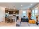 Open concept living room and kitchen with ample lighting and contemporary furnishings at 39167 Braxton Ln, Elizabeth, CO 80107