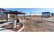 Playground and picnic area for residents with swings and covered tables, surrounded by lush landscaping at 39167 Braxton Ln, Elizabeth, CO 80107