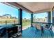 Outdoor porch with dining table, grill, dark posts, and view of fenced community at 39167 Braxton Ln, Elizabeth, CO 80107