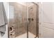 Walk-in shower with sleek glass door and tiled walls, accessorized with matching colored towel at 39167 Braxton Ln, Elizabeth, CO 80107