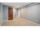 Finished basement area featuring paneled walls, carpet, and access to other rooms at 4542 S Quintero St, Aurora, CO 80015