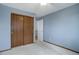 Bedroom features wall-to-wall carpet, and a closet with sliding doors at 4542 S Quintero St, Aurora, CO 80015