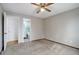 Bedroom with a ceiling fan, neutral walls, and access to an attached bathroom at 4542 S Quintero St, Aurora, CO 80015