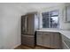 Spacious kitchen with stainless steel refrigerator, modern countertops, and gray cabinets at 4542 S Quintero St, Aurora, CO 80015