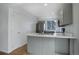 Modern kitchen featuring gray cabinets, stainless steel appliances, and updated countertops at 4542 S Quintero St, Aurora, CO 80015