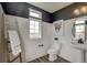 Charming powder room with shiplap walls, black trim, a pedestal sink, and a decorative ladder at 1158 Sugarloaf Ln, Erie, CO 80516
