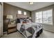Cozy bedroom features a large window, neutral carpet, and Railway Station decor at 1158 Sugarloaf Ln, Erie, CO 80516