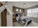 Cozy bedroom with decorative wall art and a large window providing natural light and neighborhood views at 1158 Sugarloaf Ln, Erie, CO 80516