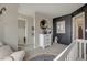 Modern Bedroom with dark accent wall, round mirror and plush rocker at 1158 Sugarloaf Ln, Erie, CO 80516