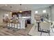 A modern kitchen with stainless steel appliances, granite countertops, an island with seating, and an adjacent dining area at 1158 Sugarloaf Ln, Erie, CO 80516