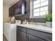 Well-lit laundry room with sink, cabinets, and modern washer and dryer for efficient cleaning at 1158 Sugarloaf Ln, Erie, CO 80516