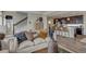 Cozy living room showcasing a comfortable sofa, stylish decor, and an open view into the modern kitchen at 1158 Sugarloaf Ln, Erie, CO 80516