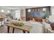 Inviting living room showcasing stylish decor, a decorative wall, and an open layout connecting to the dining area at 1158 Sugarloaf Ln, Erie, CO 80516