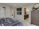 Spacious main bedroom with a view to the bathroom vanity and large dresser for plenty of storage at 1158 Sugarloaf Ln, Erie, CO 80516