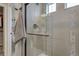 Sleek walk-in shower featuring glass enclosure, modern tile work, and upgraded fixtures at 1158 Sugarloaf Ln, Erie, CO 80516