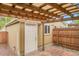 Inviting backyard space featuring a covered patio, fencing, and convenient storage at 3612 Hudson St, Denver, CO 80207