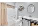 Bright bathroom featuring a shower-tub combo, tiled accent wall, and modern vanity at 3612 Hudson St, Denver, CO 80207