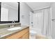 Bathroom featuring a vanity sink, granite countertops and shower with curtain at 3612 Hudson St, Denver, CO 80207