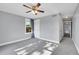 Well-lit bedroom with ceiling fan, neutral paint, and plush carpeting in a move-in-ready home at 3612 Hudson St, Denver, CO 80207