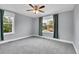 Bedroom featuring carpet flooring, light gray walls, and large windows at 3612 Hudson St, Denver, CO 80207