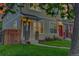Inviting entryway with brick pillar accents, wooden fence, and well-maintained lawn at 3612 Hudson St, Denver, CO 80207