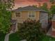 Two-story home with neutral siding, mature trees, well-kept lawn and inviting walkway leading to the front door at 3612 Hudson St, Denver, CO 80207