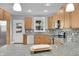 Updated kitchen with stainless steel appliances, granite countertops, mosaic backsplash, and bright lighting at 3612 Hudson St, Denver, CO 80207