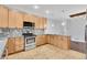 A well-lit kitchen with stainless steel appliances, tile floor, and ample cabinet space at 3612 Hudson St, Denver, CO 80207