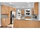 Stylish kitchen with light wood cabinets, granite countertops, stainless steel appliances, and wood flooring at 3612 Hudson St, Denver, CO 80207