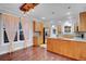 Modern kitchen features wood cabinets, granite countertops, mosaic backsplash, stainless steel refrigerator, and wood floors at 3612 Hudson St, Denver, CO 80207