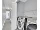 Hallway featuring modern washer and dryer with overhead shelving at 3612 Hudson St, Denver, CO 80207