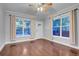 Sunlit living room boasts hardwood floors and two windows with bright natural light at 3612 Hudson St, Denver, CO 80207