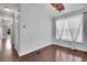 Bright and airy living room features hardwood floors, neutral walls, and a large window at 3612 Hudson St, Denver, CO 80207