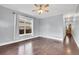 Bright living room featuring hardwood floors, a ceiling fan, large window, and neutral-colored walls at 3612 Hudson St, Denver, CO 80207