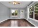 Spacious living room with hardwood floors, ample natural light, and a white front door at 3612 Hudson St, Denver, CO 80207