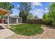 Well-maintained lawn with a detached garage, offering ample space for outdoor enjoyment and storage at 7192 W 67Th Pl, Arvada, CO 80003