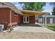 Backyard patio with an attached brick house and gravel at 7192 W 67Th Pl, Arvada, CO 80003