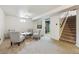 Finished basement sitting area with seating for four and stairs to upper level at 7192 W 67Th Pl, Arvada, CO 80003