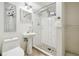Updated bathroom with a pedestal sink and tiled shower featuring a stone floor at 7192 W 67Th Pl, Arvada, CO 80003