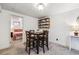Dining area with a table set for four and view into the adjacent bedroom at 7192 W 67Th Pl, Arvada, CO 80003