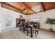 Dining room with brick fireplace and hearth, wood ceiling and seating for six at 7192 W 67Th Pl, Arvada, CO 80003