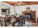 Dining room with exposed brick, view of kitchen, and seating for six at 7192 W 67Th Pl, Arvada, CO 80003